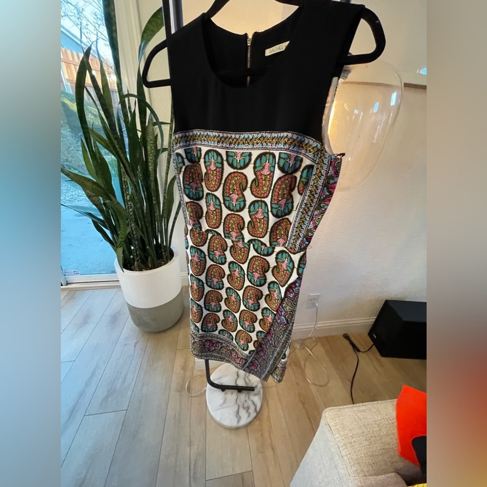 Above the knee dress, skirt has a faux wrap opening, zipper closure in back.